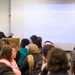 Man leading workshop, speaking in microphone